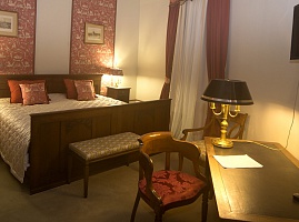 Двухспальная кровать и письменный стол в номере полулюкс